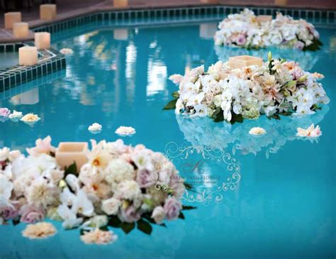 Tropical floral arrangements, heart shaped floral wreaths, and floating candles or lanterns are all popular choices that can add something. Floating flowers and candlelight | Tran | Pool wedding ...