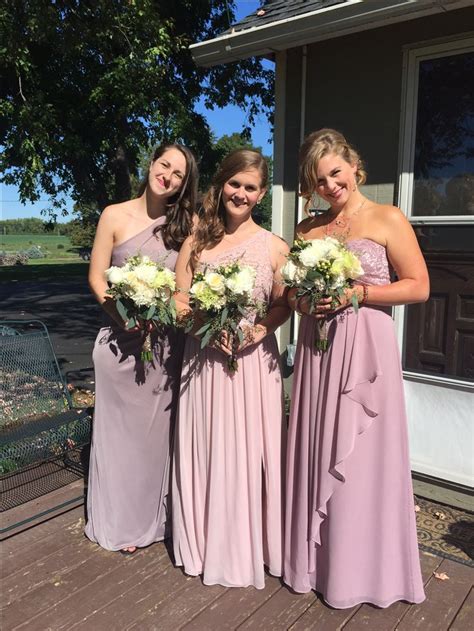 Four Bridesmaids Pose For A Photo In Front Of A House