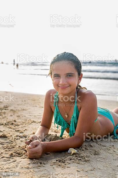 Smiling Teenage Girl Relaxing On The Beach During Summer Day Stock