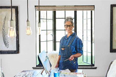 Artist Portrait Of Mature Woman With Grey Hair In Her Art Studio In