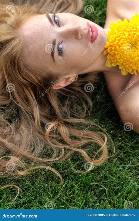 Girl Lying On The Grass With Yellow Flowers Stock Image Image Of