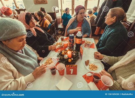 Elderly Poor Women Having Lunch At The Christmas Charity Dinner For The