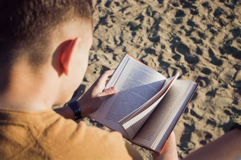 Man Reading Book At Sandy Plains · Free Stock Photo