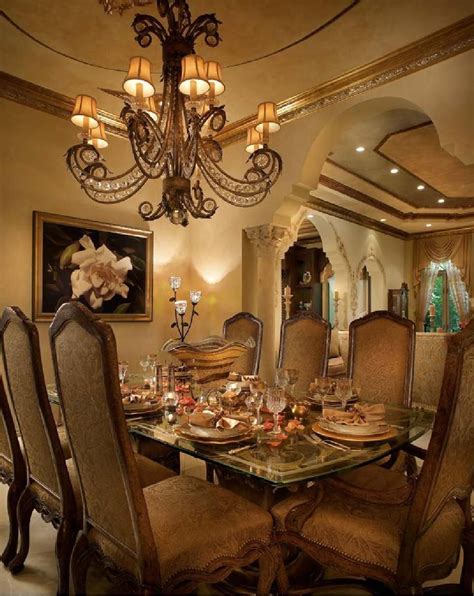 A Fancy Dining Room With Chandelier And Glass Table