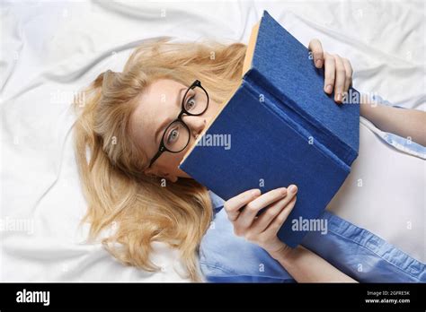 Beautiful Girl Reading Book On Bed Stock Photo Alamy