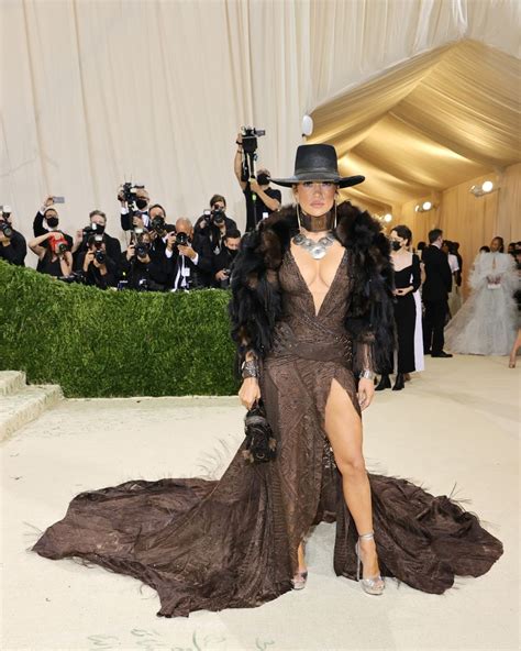 Jennifer Lopez Wears A Plunging Feathered Ralph Lauren Gown At The