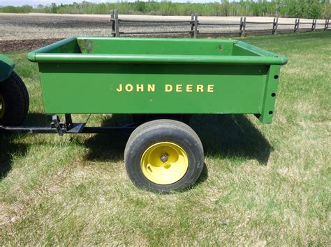 Dunkle Auction Services John Deere 80 Self Dumping Metal Garden Wagon