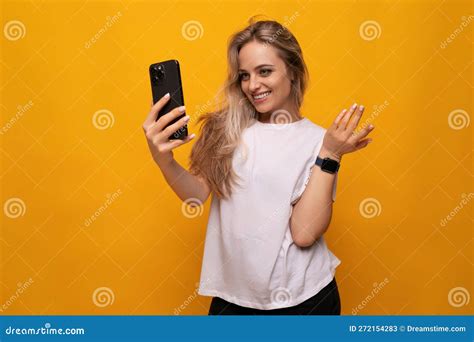 girl takes a selfie on the phone on a yellow background stock image image of girl positive