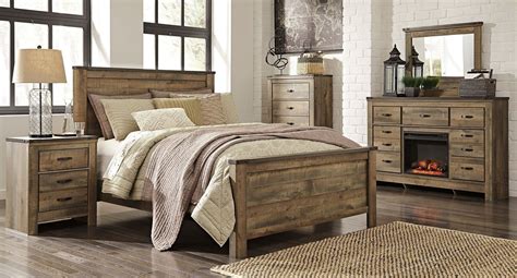 Rustic wood and repurposed items are commonly found in the farmhouse style. Trinell Panel Bedroom Set | Rustic bedroom furniture, King ...