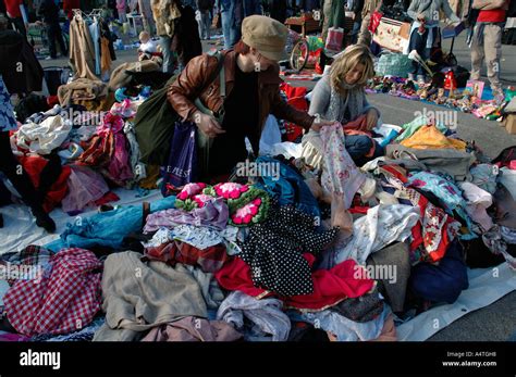 People Going Through Piles Of Clothes Looking For Bargains At A Boot Sale In South London Stock