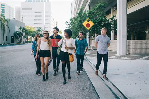 Young People Walking Around Downtown Del Colaborador De Stocksy