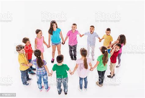 Large Group Of Happy Children Playing Ringaroundtherosy Stock Photo
