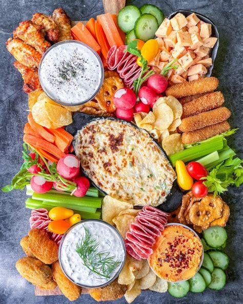 An Assortment Of Appetizers And Dips Arranged In A Circle On A Table