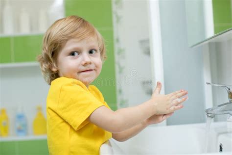 Little Boy In A Bathroom Washes Hand With Soap Stock Photo Image Of