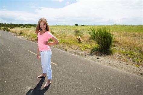 A Teenage Girl Travels Barefoot On An Empty Road Stock Image Image Of