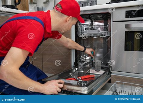 Home Appliance Maintenance Repairman Repairing Dishwasher In Kitchen