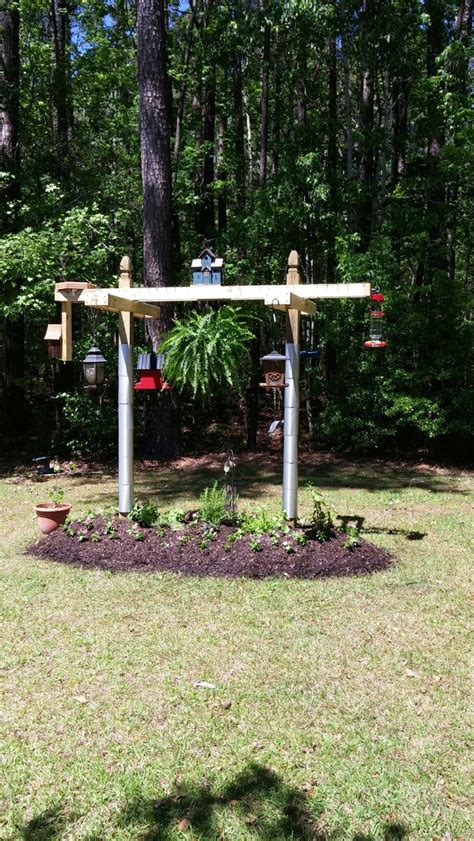 A Bird Feeding Station And Herb Garden All In One Designed Backyard