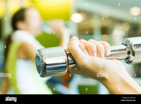 Womans Hand Holding Dumbbell Close Up Stock Photo Alamy