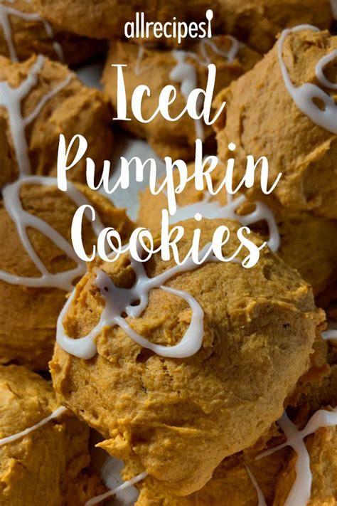 Iced Pumpkin Cookies With White Icing And Drizzled In The Middle On A Plate