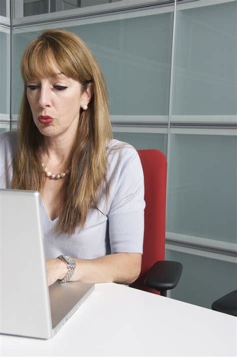 Blonde Woman Using Laptop While Sitting On The Red Chair Free Image Download