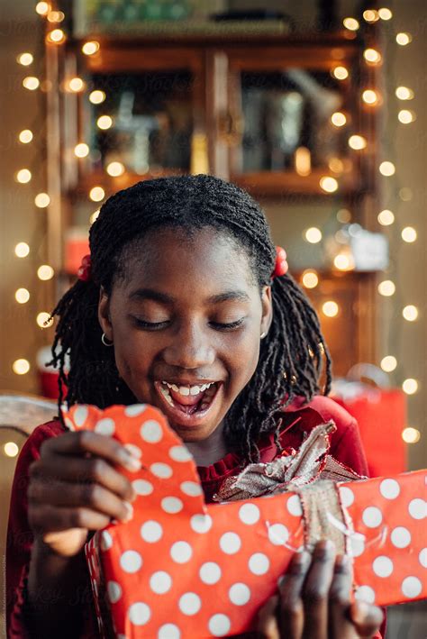 Happy Black Girl Ripping Open A Christmas Present By Gabriel Gabi