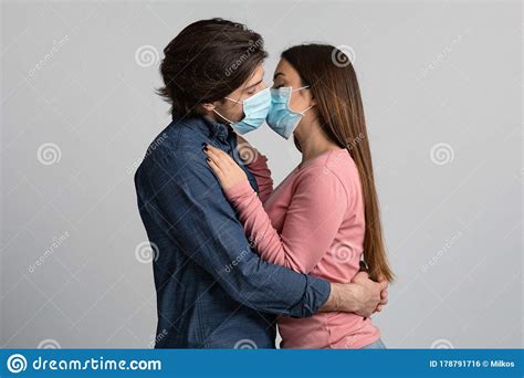 Quarantine Romantic Young Couple Kissing Each Other With Protective