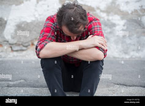 Sad Man Sitting Alone In The Street Of The City Stock Photo Alamy