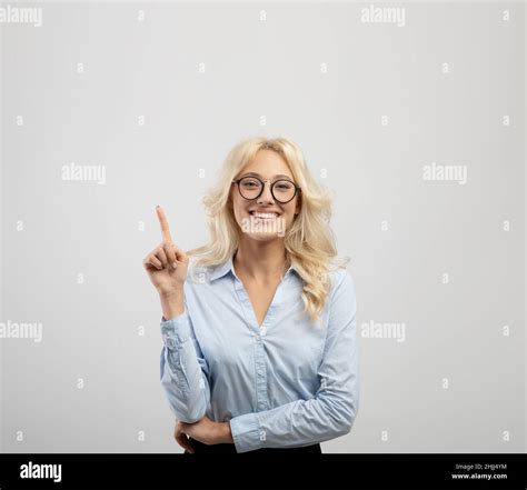 Look There Portrait Of Happy Female Office Worker Pointing Finger Up
