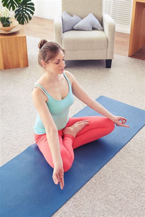 Relaxed Smiling Girl Doing Lotus Posture On Yoga Mat Stock Image