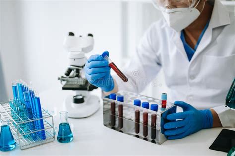 Male Scientist Researcher Conducting An Experiment In Laboratory Stock