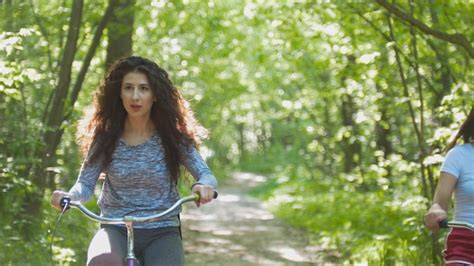 Premium Photo Cyclist Brunette Rides A Bike On A Background Of Green
