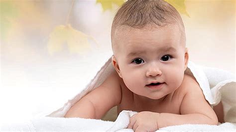 Cute Baby Is Lying Down On White Towel Covered With White Towel In