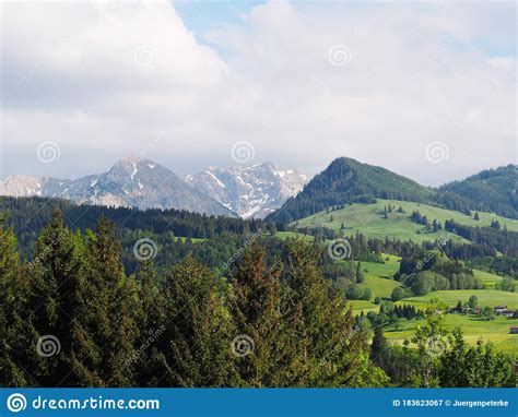 Landscape In Sunshine With Forests Meadows And Snow Capped Mountains