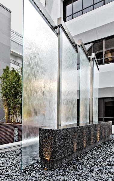 Glass Water Wall And Stone Feature In An Exterior Lounge Home
