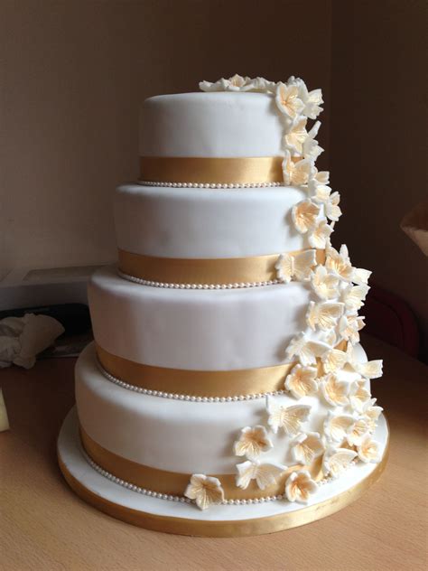 White And Gold Wedding Cake With Cascading Flowers And Butterflies With Images Gold Cake