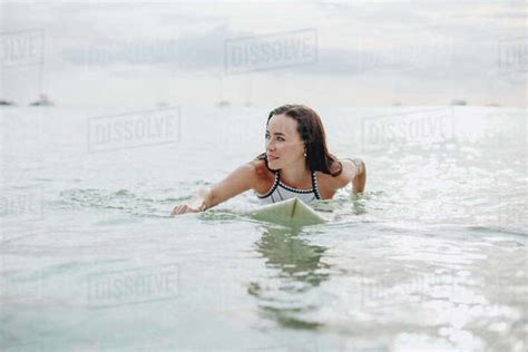Beautiful Girl Swimming On Surfboard In Water Stock Photo Dissolve