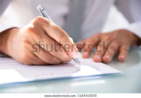 Businessmans Hand Filling Contract Form Pen Stock Photo 1164153070