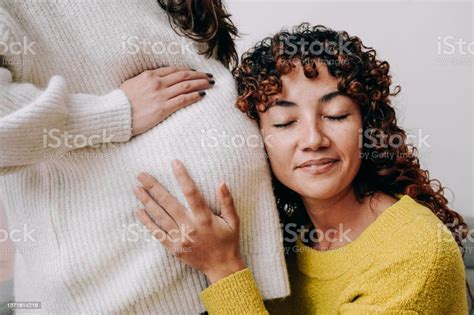 Lgbt Lesbian Pregnant Woman Having Tender Moment Listening Her Wife