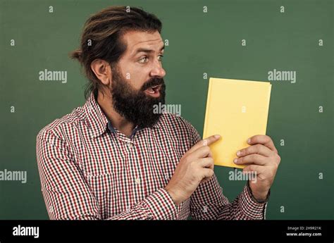 Look At That Informal Education Surprised Mature Teacher Reading Book Brutal Bearded Man Work