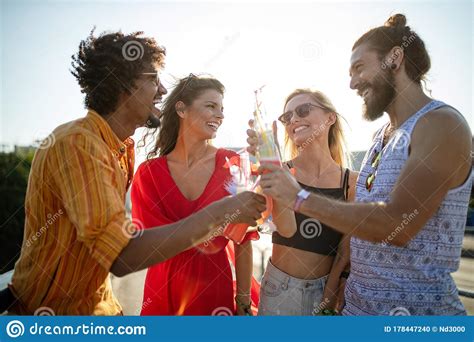 Happy Young Group Of Friends Attending Festivals At Summer Stock Photo