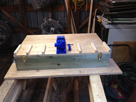 A Wooden Box Sitting On Top Of A Table In A Room Filled With Wood Planks