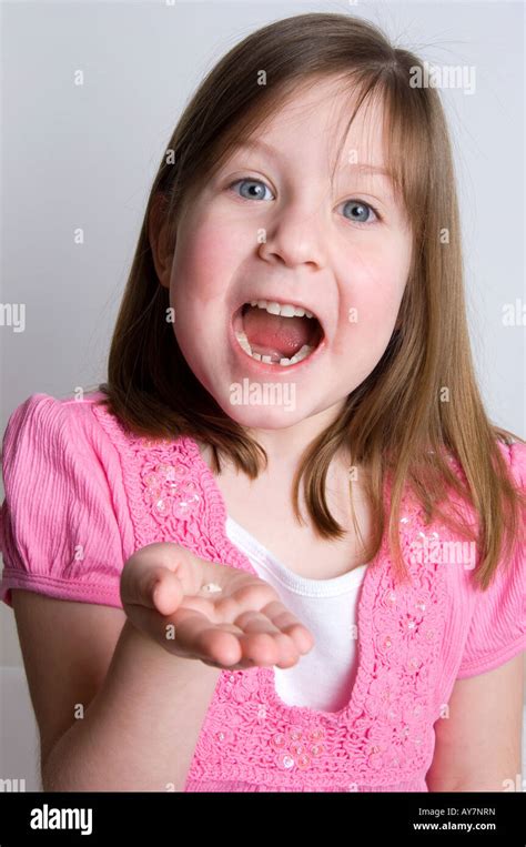Little Girl Excitedly Showing A Tooth Recently Fallen Out Along With