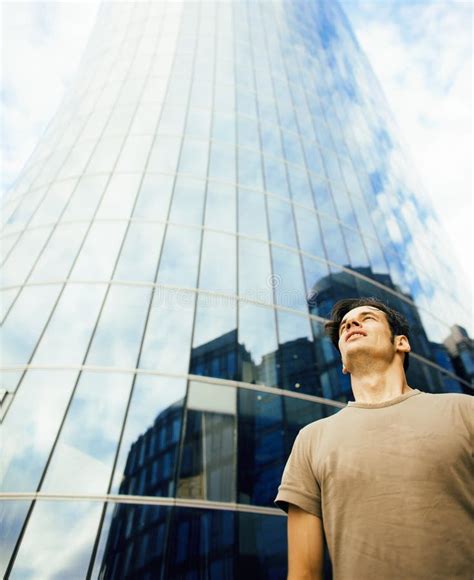 Young Man Stand In Front Of Modern Business Building Stock Photo