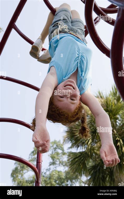 Girl Hanging Upside Down From Jungle Gym At A Playground Play Nude Girl Hanging Upside Down 19