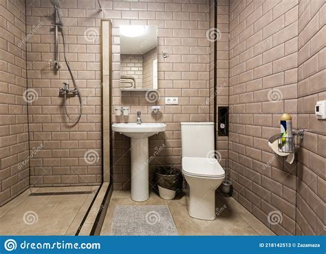 guy in bathroom covered with foam with toiletries and stairs on background macho sitting naked