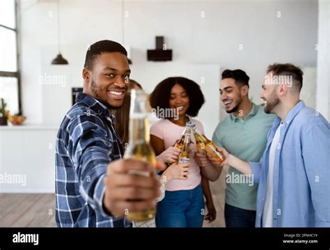 Cool Black Guy With Bottle Of Beer And Group Of Multiracial Friends