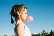 Cute girl blowing bubble gum | Free Photo