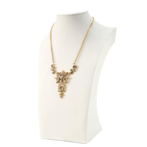 This 15 Inch Gold Chain Necklace Hangs A Gold Flower Pendant And The