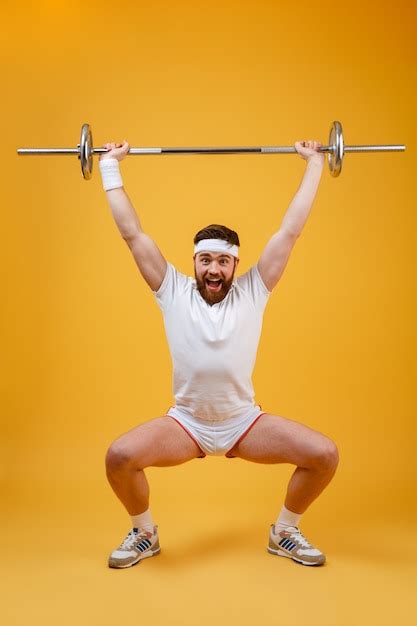 Free Photo Full Length Portrait Of A Fitness Man Squatting With Barbell