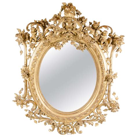 French Rococo Oval Mirror With 24 Karat Gold Gilt And Foliage Details